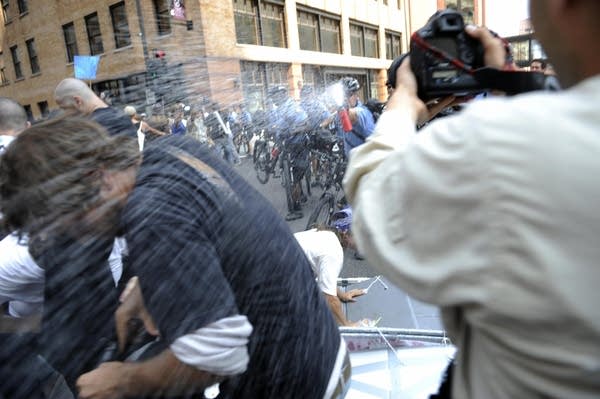 A protester gets hit by pepper spray