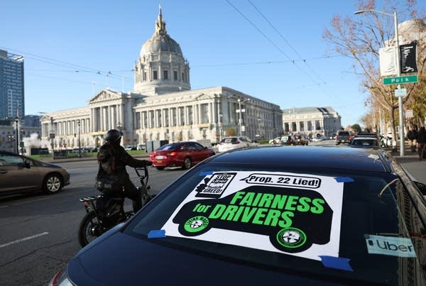 SAN FRANCISCO, CALIFORNIA - DECEMBER 13: A sign is posted on a car as gig workers with the California Gig Workers Union stage a rally against Proposition 22 outside of the California First Appellate District Court of Appeal on December 13, 2022 in San Francisco, California. Dozens of gig workers with the California Gig Workers Union rallied outside of a California courthouse in hopes of the court declaring Proposition 22 unconstitutional. Proposition 22 was a California ballot initiative that was passed in November 2020 that grants app-based transportation and delivery companies to classify their drivers as independent contractors which exempts employers from providing mandated employee benefits like overtime pay, health care, paid sick leave and unemployment insurance. (Photo by Justin Sullivan/Getty Images)