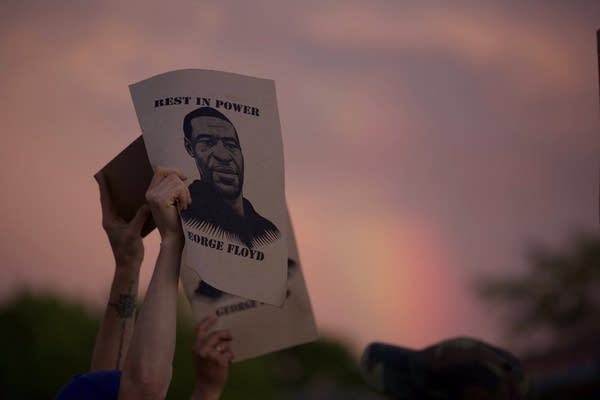 A man's image on a sign with words "Rest in Power. George Floyd."