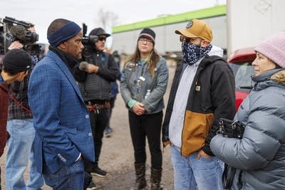 Mayor Melvin Carter stands and talks with protesters.