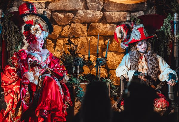 Two people dressed in ren fair costumes.