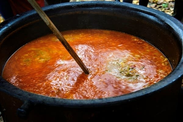 a 55-gallon pot filled with orange soup