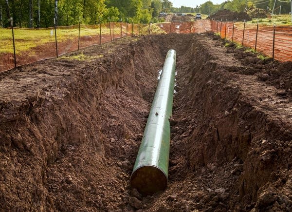 A new segment of pipeline sits in the ground near Superior, Wis.