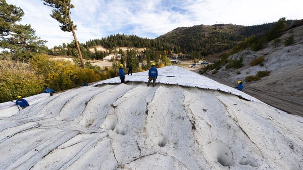 Bogus Basin's stored snow being uncovered in October 2025. The Boise, Idaho, ski resort used this snow to open its terrain park and small skiing lane last Thanksgiving. 