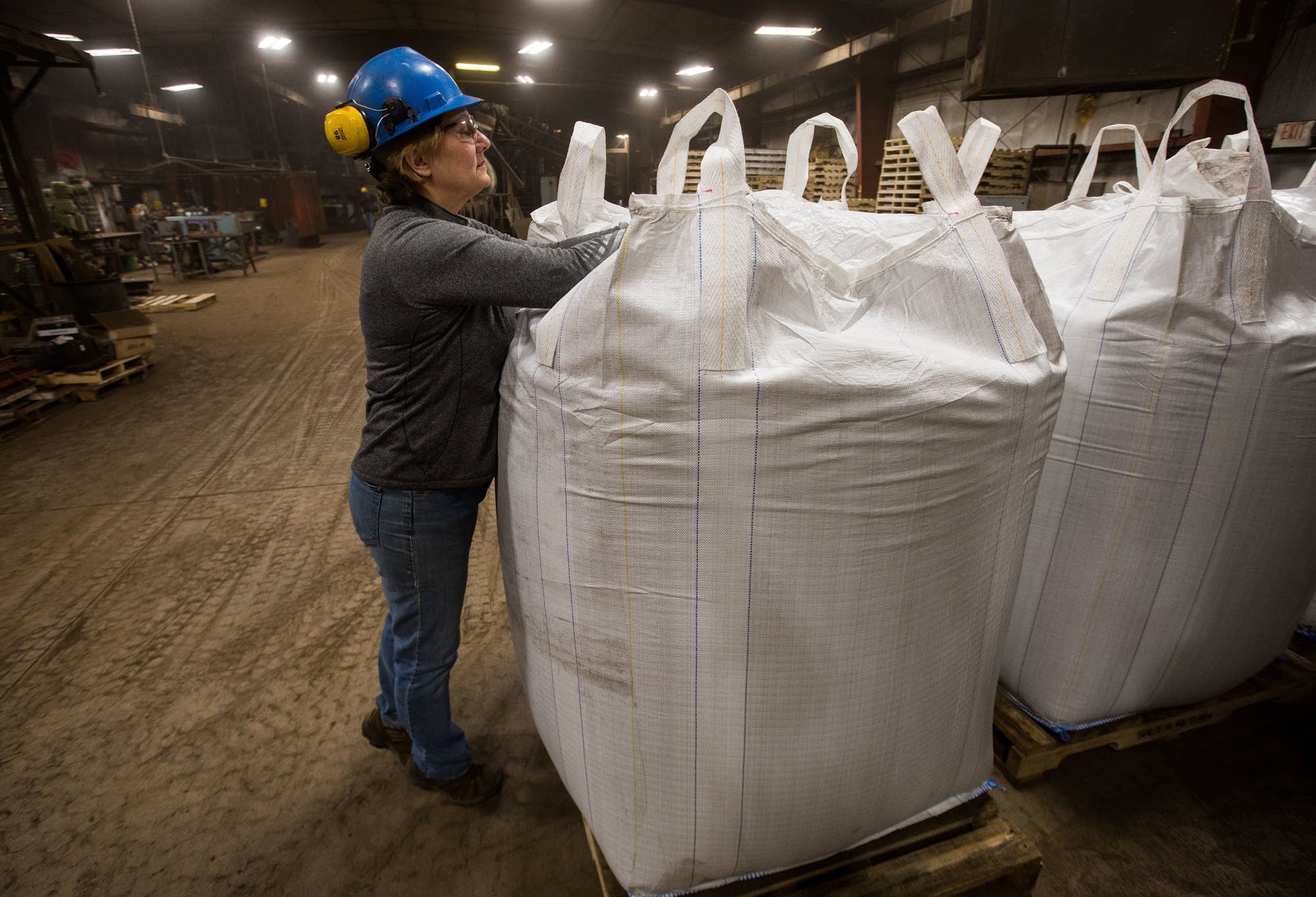 Peggy Wallgren Jones opens up a one ton bag of Bioapt.