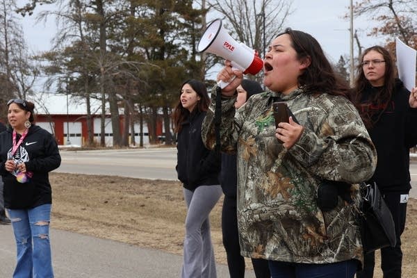 A woman yells into a microphone 