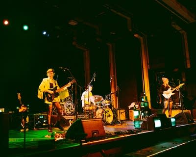 A band performing onstage in a music venue