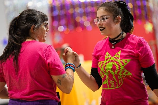 Two people shake hands