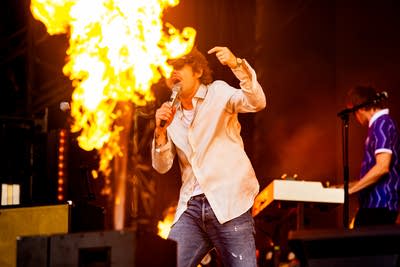 Cage the Elephant performing on an outdoor stage.