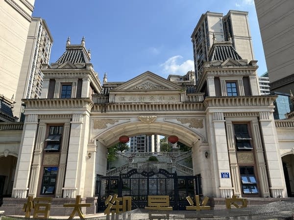 An arched gateway into a housing complex.