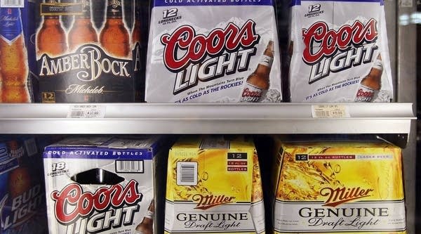 Miller, Coors and Anheuser-Busch products sit side-by-side in a cooler at a liquor store. Coors Light is now the second more popular beer in the country, after Bud Light.