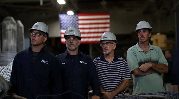 Steel workers look on during a campaign rally with democratic presidential nominee former Secretary of State Hillary Clinton and democratic vice presidential nominee U.S. Sen Tim Kaine (D-VA) at Johnstown Wire Technologies on July 30, 2016 in Johnstown, Pennsylvania. 