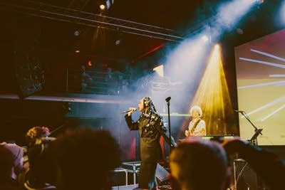 Dua Saleh sings into a microphone at Fine Line.