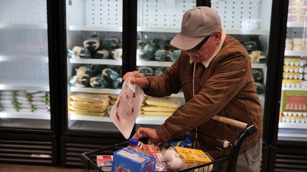 A man picks up groceries at a free market run by the Central California Food Bank in Fresno, California, on Wednesday.
