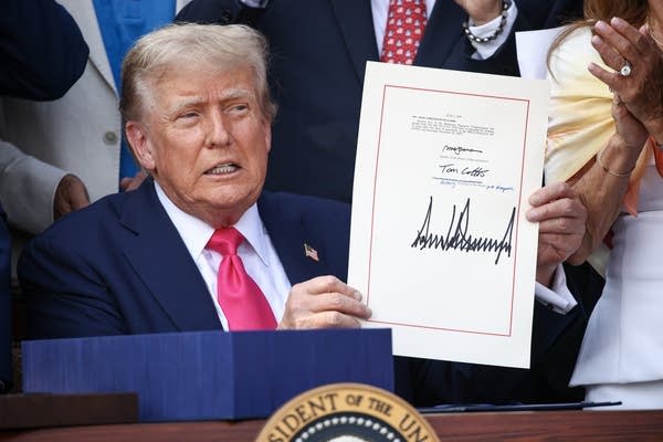 U.S. President Donald Trump, joined by Republican lawmakers, signs the One, Big Beautiful Bill Act into law during an Independence Day military family picnic on the South Lawn of the White House on July 04, 2025 in Washington, DC. 
