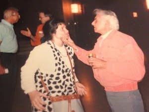 Leonard Bernstein grabs Angelina Reaux's cheeks.