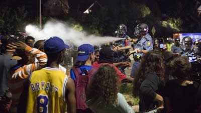 St. Paul police spray a protester.