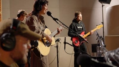 A band performing in a recording studio