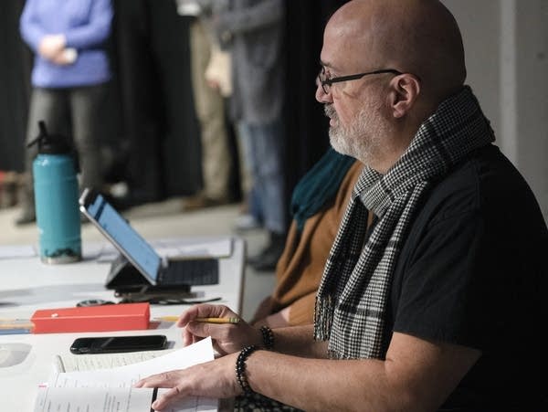 Director Richard Hitchler takes notes during a rehearsal