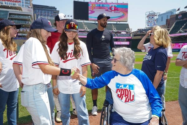 A former player shakes hands