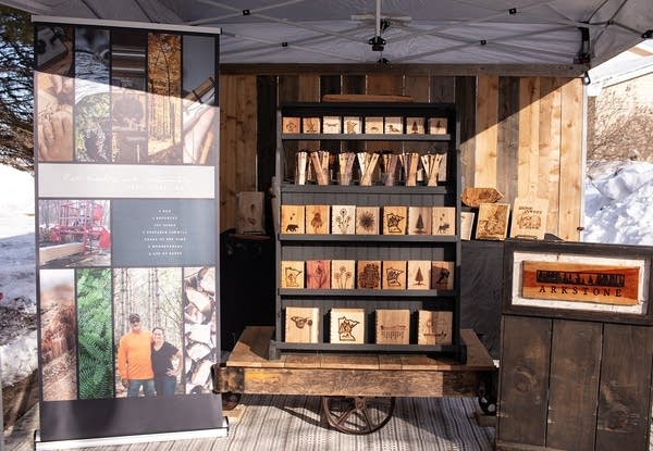 a booth with wooden art pieces