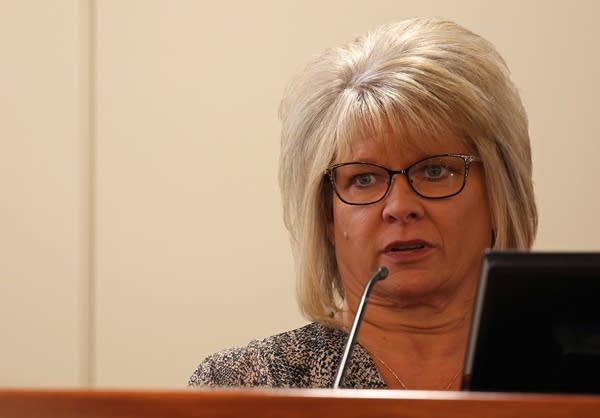 A woman speaks while in the witness stand.