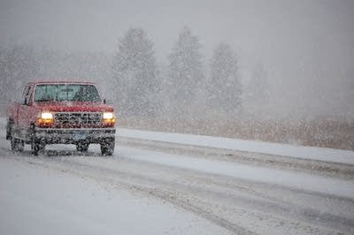 Truck tries to navigate snowy highway