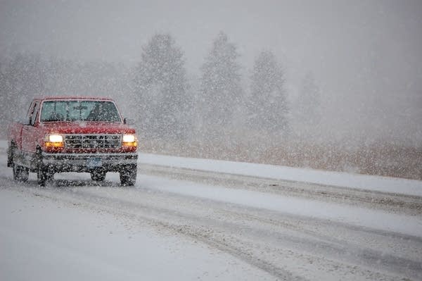 Truck tries to navigate snowy highway