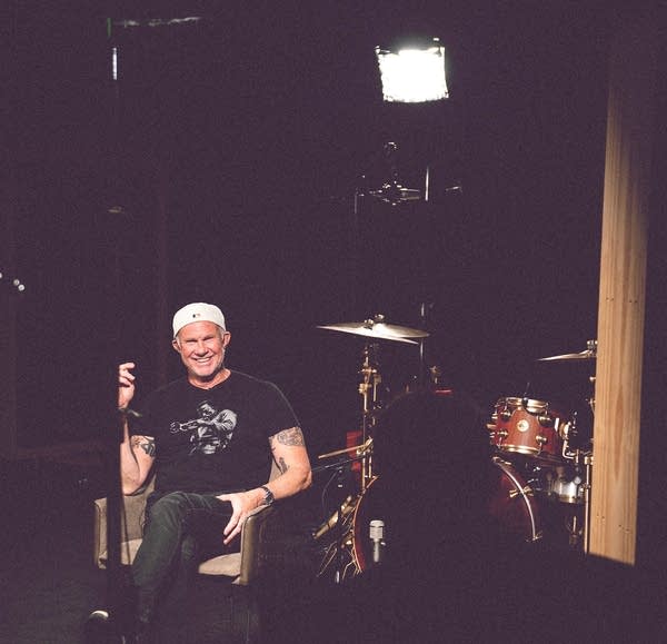 Man smiles sitting under light