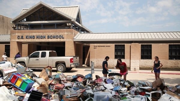 Needing to rebuild and re-purchase supplies after a flood can be very expensive for schools and their communities, said Matt Casale with the Public Interest Research Group. Above, volunteers clean a school in Houston after flooding from Hurricane Harvey in 2017. 