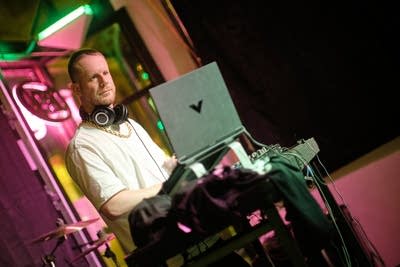 A DJ performs onstage