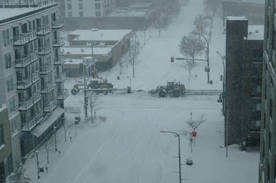 Aerial shot of snowplows working on downtown Rochester.
