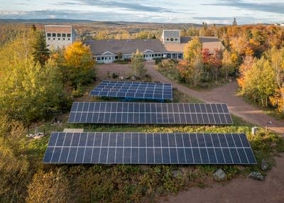 an aerial shot of solar panels and a building