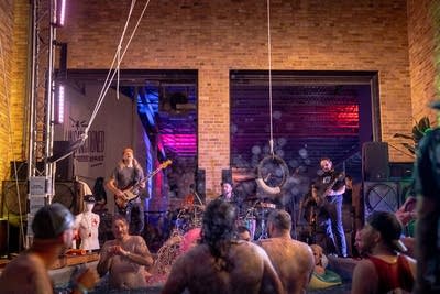 a band playing at an outdoor event with pools