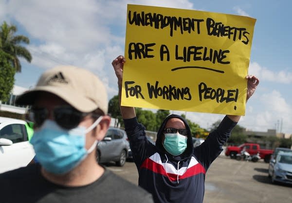 Protesters ask senators to support the continuation of unemployment benefits Thursday in Miami Springs, Florida.