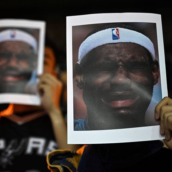 Protesters hold photographs of Lakers player LeBron James grimacing at a protest in Hong Kong on October 15, 2019. 
