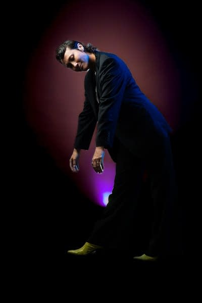 A woman poses for a studio portrait