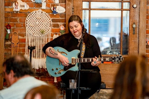 Laura Hugo performing with a guitar 2