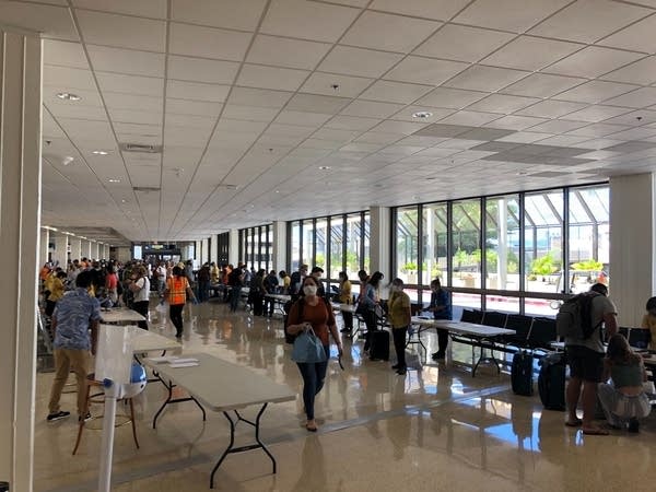 Workers verify the results of passengers’ COVID-19 tests upon landing.