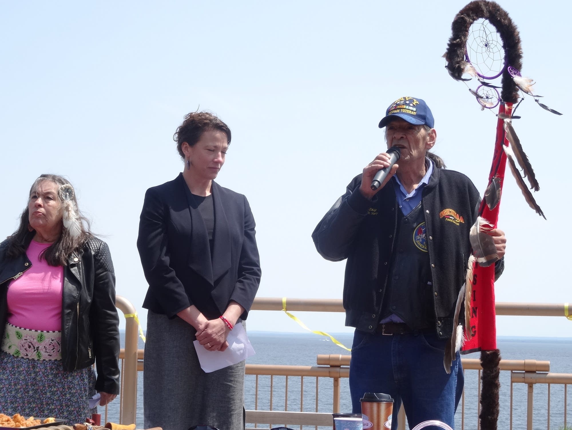 Fond du Lac tribal elder Skip Sandman presents an Eagle Staff