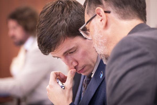 People talk in a courtroom