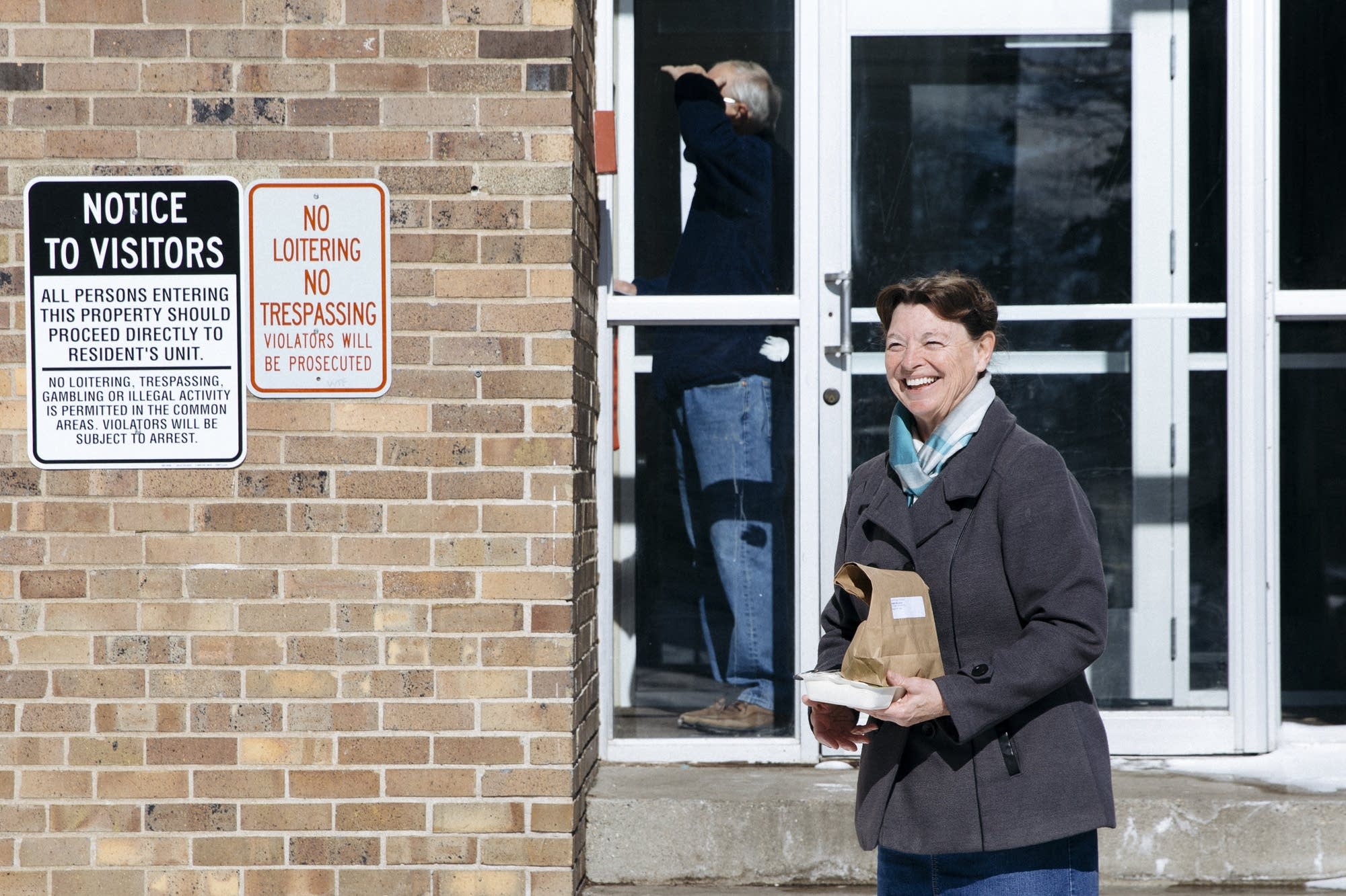 Judy Jones waits outside of an apartment building in Brooklyn Center.