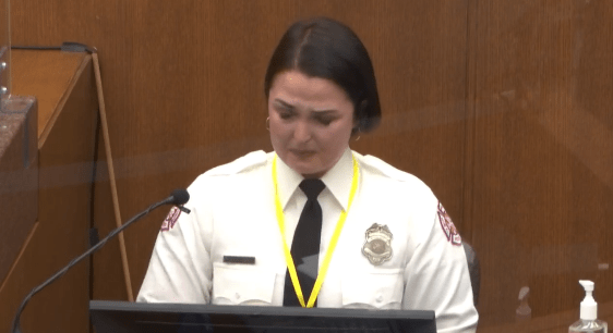 A woman stands at a podium to speak.