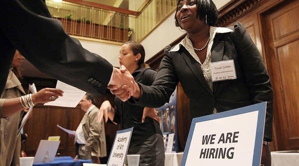  A job seeker shakes hands with a recruiter during a job fair in San Francisco, California.