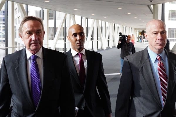 Mohamed Noor with his attorneys Peter Wold and Thomas Plunkett.