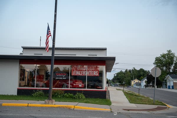 A banner in the window of a car shop reads, "Thank you firefighters."