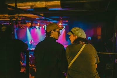 Two people watching performance