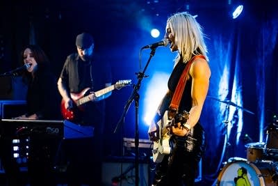 A band performing onstage in a music venue