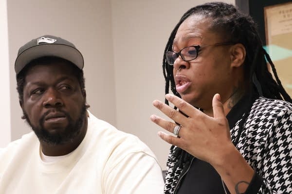 Man looks at woman while she speaks