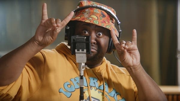 A musician strikes a cool pose in a recording studio